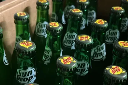 Family-Owned Soda Company Keeps Returnable Glass Bottle Tradition Alive In the US, about 127 billion plastic bottles are bought every year. Yet one Midwestern soft drink company is holding on to the old-school way of selling soda in returnable glass bottles. A Tradition Almost Lost Until the 1960s, most soda bottles in the US were designed to be returned. Customers paid a deposit for sturdy glass bottles, which they returned to stores for a refund. The bottles were then washed and refilled repeatedly. The rise of plastic bottles phased out this system, but Twig's Beverage, a family-owned company in Shawano County, Wisconsin, has kept it alive. Customers pay a $20 deposit for a case of 24 bottles. They can even visit Twig's factory in Shawano to refill bottles, some of which are over 60 years old. Nostalgia and Community Ben Hartwig, Twig's vice-president, says families have been bringing back the same bottles for generations. "Cases get passed down, and the next family member brings them in," he says. "Long-time customers love the nostalgic feel and treat these cases like gold." Some 16oz bottles still date back to the 1960s and 70s, and they continue to go through Twig's washing process today. Sun Drop and Real Sugar Established in 1951 by Floyd Hartwig, Twig's signature soda is Sun Drop, a citrus-flavored drink first developed in Missouri in the 1940s. Although US drinks giant Keurig Dr Pepper owns the brand, Twig's makes Sun Drop under license for sale in its Wisconsin territory. It is the last Sun Drop producer to use returnable glass bottles instead of plastic and one of the few still using real sugar instead of high fructose corn syrup. Twig's also produces its own line of fruit sodas, including root beer, black cherry, orange, and lime. While Sun Drop can only be sold in Wisconsin, Twig's is expanding its own soda brand across the Midwest. These new bottles will not be returnable due to distance, so customers outside the state are encouraged to recycle them. Family Business and Local Culture Twig's story began when Floyd Hartwig, recovering from wounds in the Korean War, conceived the soda business idea. Post-World War Two economic growth and a rise in take-home drinks helped the business flourish. In 1986, Floyd’s son Dan took over to keep the company in the family. Today, Ben Hartwig runs Twig's with his wife Annelies and brothers Jake and Luke. The company employs 20 people and earns around $6.5 million annually. Sun Drop Dayz, a local fundraiser with live music and activities, has been celebrated every June since 2017. Visitors can also tour Twig's museum to see the soda-making process firsthand. Looking Ahead Twig's continues to honor its tradition of returnable glass bottles while expanding its own soda brand in the Midwest. With a focus on nostalgia, real sugar, and community, the company blends heritage with growth.