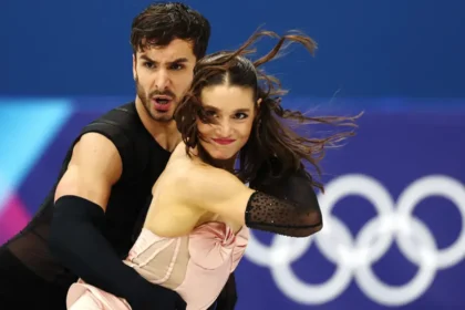 France Ice Dance Controversy: Gold at Stake Amid Rivalry and Drama The ice dance event at Milan Cortina 2026 is heading toward a dramatic finish. Two elite teams are fighting for Olympic gold, and the margin between them is razor thin. American duo Madison Chock and Evan Bates sit in second place. The married pair already won gold in the team event and hold three world titles. They have skated together since 2011 and bring years of chemistry to the ice. Just 0.46 points ahead are France’s Guillaume Cizeron and Laurence Fournier Beaudry. They teamed up only last November, yet they have already made a huge impact. Cizeron, the reigning Olympic champion, aims to win back to back titles. A New Partnership, Instant Results Cizeron won Olympic gold at Beijing 2022 with Gabriella Papadakis. After their split, he formed a new partnership with Fournier Beaudry. The decision raised eyebrows, but the results speak loudly. The French pair delivered a technically sharp rhythm dance to Madonna’s Vogue. Judges awarded them a stronger technical score on their step sequence than the Americans. That edge gave them the slim lead. Since joining forces, they have won four of five major events. One of those victories came at the 2026 European Championship in Sheffield. Their only loss happened at the Grand Prix Final, where Chock and Bates beat them. The final medals will depend on the free dance. Unlike the rhythm dance, the free program gives skaters more creative control. Both segments combined will decide the champion. Judging Debate Adds More Tension Figure skating judging has sparked debate for decades. Ice dance relies on both technical elements and artistic interpretation. Even small scoring differences can decide medals. This time, less than half a point separates gold from silver. That tiny gap keeps fans guessing. Fallout From a Bitter Split The drama off the ice rivals the competition itself. Cizeron’s former partner, Gabriella Papadakis, released a memoir earlier this year. In it, she described their partnership as unbalanced. She said she felt controlled and pressured during their years together. Cizeron strongly denied the claims. He called the book a smear campaign and said it spreads false information. He has started legal action in response. The situation also affected Papadakis professionally. NBC removed her from its Olympic analyst role, citing a conflict of interest linked to her memoir. Citizenship Change and Fresh Controversy Fournier Beaudry’s journey to Team France also stirred debate. She previously competed for Canada and Denmark. France granted her citizenship in November so she could skate with Cizeron at the Games. Before this partnership, she skated with Canadian athlete Nikolaj Sorensen, who is also her partner in real life. In 2025, officials handed Sorensen a six year suspension after a sexual assault allegation dating back to 2012. The case involves an American skating coach. It does not involve Fournier Beaudry. Sorensen denies the allegation and calls it false. Fournier Beaudry has publicly supported him. In a Netflix documentary, she said she fully trusts him. The anonymous complainant criticized her comments. The accuser argued that such statements could discourage others from reporting abuse. Since gaining French citizenship, Fournier Beaudry has declined further comment on the issue. All Eyes on the Free Dance Now, the focus returns to the ice. Cizeron and Fournier Beaudry hold a narrow lead. Chock and Bates bring experience and consistency. The free dance will test not only skill but also nerve. One small mistake could change everything. At Milan Cortina 2026, the battle for gold carries more than medals. It carries history, rivalry, and controversy that has followed these skaters all the way to the Olympic stage.