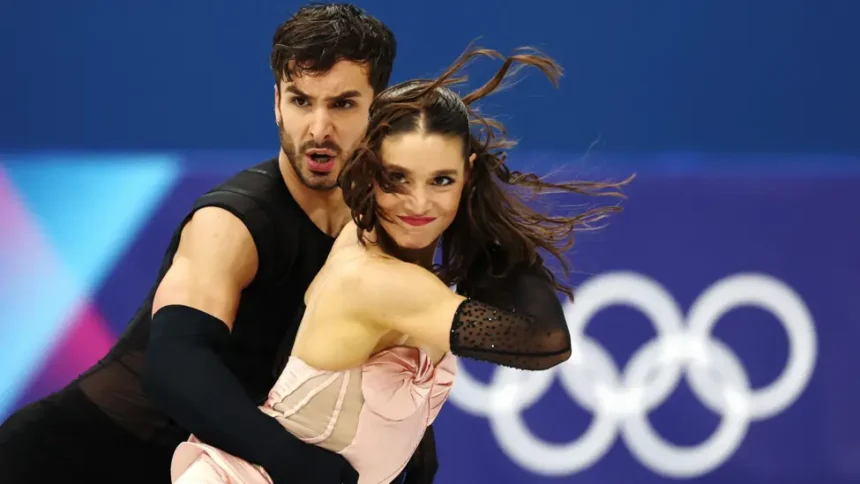 France Ice Dance Controversy: Gold at Stake Amid Rivalry and Drama The ice dance event at Milan Cortina 2026 is heading toward a dramatic finish. Two elite teams are fighting for Olympic gold, and the margin between them is razor thin. American duo Madison Chock and Evan Bates sit in second place. The married pair already won gold in the team event and hold three world titles. They have skated together since 2011 and bring years of chemistry to the ice. Just 0.46 points ahead are France’s Guillaume Cizeron and Laurence Fournier Beaudry. They teamed up only last November, yet they have already made a huge impact. Cizeron, the reigning Olympic champion, aims to win back to back titles. A New Partnership, Instant Results Cizeron won Olympic gold at Beijing 2022 with Gabriella Papadakis. After their split, he formed a new partnership with Fournier Beaudry. The decision raised eyebrows, but the results speak loudly. The French pair delivered a technically sharp rhythm dance to Madonna’s Vogue. Judges awarded them a stronger technical score on their step sequence than the Americans. That edge gave them the slim lead. Since joining forces, they have won four of five major events. One of those victories came at the 2026 European Championship in Sheffield. Their only loss happened at the Grand Prix Final, where Chock and Bates beat them. The final medals will depend on the free dance. Unlike the rhythm dance, the free program gives skaters more creative control. Both segments combined will decide the champion. Judging Debate Adds More Tension Figure skating judging has sparked debate for decades. Ice dance relies on both technical elements and artistic interpretation. Even small scoring differences can decide medals. This time, less than half a point separates gold from silver. That tiny gap keeps fans guessing. Fallout From a Bitter Split The drama off the ice rivals the competition itself. Cizeron’s former partner, Gabriella Papadakis, released a memoir earlier this year. In it, she described their partnership as unbalanced. She said she felt controlled and pressured during their years together. Cizeron strongly denied the claims. He called the book a smear campaign and said it spreads false information. He has started legal action in response. The situation also affected Papadakis professionally. NBC removed her from its Olympic analyst role, citing a conflict of interest linked to her memoir. Citizenship Change and Fresh Controversy Fournier Beaudry’s journey to Team France also stirred debate. She previously competed for Canada and Denmark. France granted her citizenship in November so she could skate with Cizeron at the Games. Before this partnership, she skated with Canadian athlete Nikolaj Sorensen, who is also her partner in real life. In 2025, officials handed Sorensen a six year suspension after a sexual assault allegation dating back to 2012. The case involves an American skating coach. It does not involve Fournier Beaudry. Sorensen denies the allegation and calls it false. Fournier Beaudry has publicly supported him. In a Netflix documentary, she said she fully trusts him. The anonymous complainant criticized her comments. The accuser argued that such statements could discourage others from reporting abuse. Since gaining French citizenship, Fournier Beaudry has declined further comment on the issue. All Eyes on the Free Dance Now, the focus returns to the ice. Cizeron and Fournier Beaudry hold a narrow lead. Chock and Bates bring experience and consistency. The free dance will test not only skill but also nerve. One small mistake could change everything. At Milan Cortina 2026, the battle for gold carries more than medals. It carries history, rivalry, and controversy that has followed these skaters all the way to the Olympic stage.