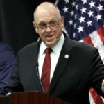 The Trump administration has announced plans to withdraw 700 federal immigration agents from Minnesota. These officers were part of Operation Metro Surge, a major immigration crackdown launched in Minneapolis late last year. White House Border Czar Tom Homan shared the decision during a press conference in Saint Paul on Wednesday. He said the pullback would start immediately. Federal Presence to Be Reduced Gradually According to Homan, agents from Immigration and Customs Enforcement and the US Border Patrol will be included in the withdrawal. Around 2,000 federal agents will remain in Minnesota for now. Homan explained that the administration wants to return to the staffing level that existed before the operation began in December. He said the decision reflects improved cooperation from state and local authorities. He added that federal officials will continue adjusting the number of agents based on local support and coordination. Body Cameras a National Priority During the briefing, Homan said the government is prioritizing body worn cameras for all officers operating in Minnesota. He confirmed that every federal agent in Minneapolis will receive the equipment. The administration also plans to expand body camera use nationwide. Homan said the move aims to improve transparency and accountability during enforcement actions. Operation Called a Success Despite Controversy Homan described Operation Metro Surge as a success, even though it faced legal challenges and public criticism. The operation has sparked nationwide protests and intense debate. Two US citizens, Renee Good and Alex Pretti, died after federal agents shot them during enforcement actions. Their deaths remain a major point of concern for civil rights groups. Homan acknowledged that the operation was not perfect. He said federal agencies improved coordination by creating a clearer chain of command. He noted that the operation now runs more smoothly than before. Arrest Numbers Highlight Enforcement Impact Federal agents have arrested hundreds of individuals since the operation began. Homan said officers detained people accused of serious crimes. These include 14 individuals charged with homicide, 139 charged with assault, 87 registered sex offenders, and 28 alleged gang members. The BBC has not independently confirmed these figures. Homan said the goal of the operation was to remove dangerous individuals from communities. He stressed that public safety remains the administration’s top priority. Cooperation Led to Agent Reduction Homan took direct control of the operation at the end of January. At the time, he said federal staffing would depend on how much support local officials provided. On Wednesday, he said Minnesota authorities showed unprecedented cooperation. That cooperation, he said, led to the decision to cut the federal presence by roughly one third.