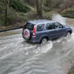 Are Wetter Winters and Frequent Flooding in the UK the New Normal? Heavy rain has soaked the UK again. From Cornwall to County Down, many areas recorded their wettest January ever. February brought more downpours, adding pressure to already saturated ground. Weather experts say this may not be a one off event. Wetter winters are becoming more common across the UK. Why Is So Much Rain Falling? Meteorologists link the recent flooding to a blocked weather pattern. A high pressure system over Scandinavia has trapped storm systems over the UK. As a result, rain clouds cannot move away easily. But this pattern tells a bigger story. Climate change plays a key role. When we burn fossil fuels such as coal and oil, we release greenhouse gases into the atmosphere. These gases trap heat and warm the planet. Even small temperature increases matter. For every 1°C rise in global temperature, the atmosphere can hold about 7 percent more moisture. More moisture means heavier rainfall. This is one reason the UK now faces more intense winter rain than in the past. Wet Winters Are Becoming More Frequent The Met Office reports that six of the ten wettest winters in nearly 250 years happened during this century. That is a clear shift. In the past, winters like 2023 to 2024 occurred roughly once every 80 years. Today, they happen about once every 20 years. If global warming continues, these extreme wet winters could become even more common. Natural weather patterns still influence UK rainfall. However, long term data shows a steady trend toward wetter winters. Rising Sea Levels Increase the Risk Rain is not the only concern. Sea levels around the UK have risen by about 20 centimeters since 1901. Warmer oceans expand. Melting glaciers also add more water. This rise may sound small, but it increases flood risk. When storms hit during high tide, coastal communities face stronger tidal surges. The combination of heavy rain and rising seas makes flooding worse. Communities and Farmers Feel the Pressure Flood warnings continue across the country. At one point this week, more than 100 areas faced official alerts. The Environment Agency confirmed that over 300 homes flooded. Farmers are under severe strain. One Somerset farmer said he is living on a knife edge. His crops sit in floodwater and may rot within days. Flooding also disrupts transport, damages homes, and threatens food supply chains. Insurance costs may rise. Infrastructure faces growing pressure. Are These Wetter Winters Here to Stay? Climate projections suggest yes. Unless greenhouse gas emissions fall sharply, the UK will likely see more wet winters and frequent flooding. Scientists warn that warming will intensify rainfall patterns further. The key question is no longer whether winters are changing. The focus now shifts to how communities adapt.
