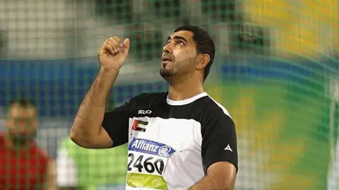 UK Athletics Admits Corporate Manslaughter in Death of Abdullah Hayayei Training Accident at Newham Leisure Centre UK Athletics has admitted corporate manslaughter over the death of Paralympian Abdullah Hayayei. The athlete died in July 2017 during a training session at Newham Leisure Centre in London. A metal throwing cage collapsed and struck him. He was 36. At first, UK Athletics denied the charge in March 2025. However, the organization changed its plea at a recent hearing at the Old Bailey. As a result, the court will now move straight to sentencing. Keith Davies, who oversaw sport at the 2017 World Para Athletics Championships, also admitted a health and safety offence. Earlier, he had denied gross negligence manslaughter. Now, he remains on bail. In addition, he must cooperate with the Probation Service for a pre sentence report. Prosecutor Karen Robinson asked the judge to fix a two day sentencing hearing in early June. She also confirmed that the prosecution will not pursue a full trial. Therefore, the court will deal with all remaining matters during sentencing. A Prominent Paralympic Career At the time of the incident, Hayayei prepared for the 2017 World Para Athletics Championships in London. He represented the United Arab Emirates in the F34 classification. He planned to compete in shot put, discus, and javelin. Moreover, London 2017 would have marked his second appearance at a world championship. Previously, he competed at the Rio 2016 Paralympic Games. There, he finished sixth in javelin and seventh in shot put. Earlier still, he took part in the 2015 World Championships in Doha. He secured fifth place in discus and eighth in shot put. Beyond sport, Hayayei was a father of five. His death shocked the athletics community. For that reason, organizers held a moment of silence during the opening ceremony at London Stadium. Sentencing Stage Ahead The court will now decide the penalties for UK Athletics and Keith Davies. Meanwhile, the case has renewed debate around safety standards in elite sport. Ultimately, the sentencing hearing in June will close a legal process that has lasted several years.