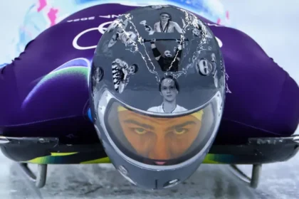 Ukrainian Skeleton Racer Wears Helmet Tribute Despite IOC Ban Ukrainian skeleton racer Vladyslav Heraskevych has chosen to wear a special helmet honoring athletes killed during Russia’s invasion of Ukraine, even after the International Olympic Committee (IOC) told him not to. He said he will continue wearing it on race days, insisting that the athletes he commemorates “deserve to be on the track.” Helmet Honors Fallen Athletes Heraskevych’s helmet features images of athletes, some of whom were his friends. Among them are teenage weightlifter Alina Peregudova, boxer Pavlo Ishchenko, and ice hockey player Oleksiy Loginov. He believes the helmet keeps their memories alive and highlights their connection to the Olympic movement. “Some of them were part of the Olympic family,” he said. “I believe they deserve to be here.” IOC Response and Rules The IOC has reminded Heraskevych that Rule 50.2 of the Olympic Charter prohibits political, religious, or racial propaganda in Olympic venues. Officials suggested wearing a black armband instead to honor the fallen athletes. IOC spokesperson Mark Adams said Heraskevych could show the helmet in mixed zones and on social media, but not while competing. He added, “We want him to compete. All athletes deserve their moment on the track.” The IOC has not confirmed if Heraskevych would face disqualification for continuing to wear the helmet. Athlete’s Stand Despite the IOC’s guidance, Heraskevych feels his helmet does not break the rules. He argued, “I believe we have all the rights to wear this helmet in competition because it is fully compliant with the rules. There aren’t enough black bands to honor all of these athletes.” Precedent of IOC Disqualifications The IOC has previously disqualified athletes for displaying political messages. For instance, Afghan breakdancer Manizha Talash, representing the Refugee Olympic Team in Paris 2024, was removed for wearing a 'Free Afghan Women' slogan during a pre-qualifier dance battle. Upcoming Races The men’s skeleton heats start Wednesday, with final runs scheduled for Friday. Heraskevych’s helmet tribute is set to draw attention while reminding the world of the lives lost during the invasion.