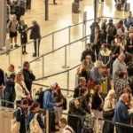 Videos shared on social media over the past week show long queues at passport control at Geneva Airport. Some travelers say they waited up to three hours to clear border checks. Geneva Airport often gets crowded during winter. Ski season brings thousands of visitors, including many from the UK. This year, however, delays have grown worse. Airport officials say a new EU border system has increased congestion at passport control. New EU Entry Exit System Causes Delays Geneva Airport has blamed the EU Entry Exit System, known as EES, for the slow movement of passengers. Officials say congestion is most common on Saturdays, which are the busiest travel days during ski season. A spokesperson said the rollout of EES has created serious challenges for Swiss customs and airport staff. The new system requires biometric checks, which take more time per passenger. To ease pressure, the airport has increased staff numbers. Even so, long queues continue during peak hours. Tenerife Also Sees Long Waiting Times Similar delays have appeared at Tenerife Airport in the Canary Islands. The island remains a top winter sun destination for British travelers. Andrew Knight, who runs Sanasty Car Hire at Tenerife Airport, says many arriving passengers struggle with long waits at border kiosks. Most of his customers come from the UK and arrive during busy flight schedules. Delays Depend on Arrival Times Passengers who land during quieter hours often pass through passport control quickly. Some clear checks in about 20 minutes. Problems start when several flights arrive close together. During these periods, queues grow fast. Some travelers wait up to two hours before reaching the kiosks. Knight says the system works unevenly. At times, technical issues shut it down completely. When that happens, delays increase and frustration grows. Peak Travel Still a Concern Airport operators warn that long queues could continue during busy travel seasons. Until systems improve, passengers may face delays at major European airports. Authorities say flexibility remains an option. Border staff can pause the new system during peak times if queues become unmanageable.