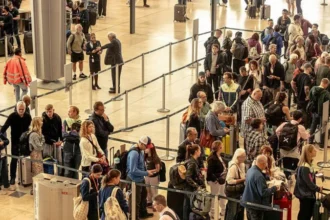 Videos shared on social media over the past week show long queues at passport control at Geneva Airport. Some travelers say they waited up to three hours to clear border checks. Geneva Airport often gets crowded during winter. Ski season brings thousands of visitors, including many from the UK. This year, however, delays have grown worse. Airport officials say a new EU border system has increased congestion at passport control. New EU Entry Exit System Causes Delays Geneva Airport has blamed the EU Entry Exit System, known as EES, for the slow movement of passengers. Officials say congestion is most common on Saturdays, which are the busiest travel days during ski season. A spokesperson said the rollout of EES has created serious challenges for Swiss customs and airport staff. The new system requires biometric checks, which take more time per passenger. To ease pressure, the airport has increased staff numbers. Even so, long queues continue during peak hours. Tenerife Also Sees Long Waiting Times Similar delays have appeared at Tenerife Airport in the Canary Islands. The island remains a top winter sun destination for British travelers. Andrew Knight, who runs Sanasty Car Hire at Tenerife Airport, says many arriving passengers struggle with long waits at border kiosks. Most of his customers come from the UK and arrive during busy flight schedules. Delays Depend on Arrival Times Passengers who land during quieter hours often pass through passport control quickly. Some clear checks in about 20 minutes. Problems start when several flights arrive close together. During these periods, queues grow fast. Some travelers wait up to two hours before reaching the kiosks. Knight says the system works unevenly. At times, technical issues shut it down completely. When that happens, delays increase and frustration grows. Peak Travel Still a Concern Airport operators warn that long queues could continue during busy travel seasons. Until systems improve, passengers may face delays at major European airports. Authorities say flexibility remains an option. Border staff can pause the new system during peak times if queues become unmanageable.