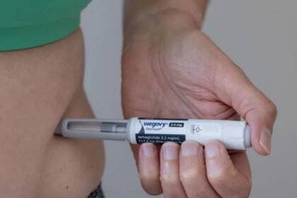 Shares of Novo Nordisk, the Danish company behind Ozempic and Wegovy, fell 18% after the firm warned of lower profits and sales. Chief Executive Maziar Mike Doustdar described the situation as “unprecedented” and “painful,” adding that challenges may get worse before they improve. Steep Price Cuts and Market Pressure Novo Nordisk expects profits and sales to drop by up to 13% due to steep price reductions. The company said the situation worsened following a deal with US President Donald Trump to lower the cost of weight-loss drugs for Americans. Doustdar, appointed CEO last summer, said the price reduction for Wegovy is intended as an “investment for the future” and aims to make the drug accessible to more people. He warned investors that the share price could fall before it rises again. Rising Competition and Patent Expiry Weight-loss drugs like Ozempic, Wegovy, and Eli Lilly’s Zepbound and Mounjaro have grown increasingly popular. Competition has driven down prices, and patent expirations have allowed low-cost copycat drugs to enter the market. Some of these copies carry safety concerns. Novo Nordisk’s Chief Financial Officer, Karsten Munk Knudsen, highlighted that patents for semaglutide in India and China will expire soon. This is expected to increase competition, impacting group sales by around 2% this year. Knudsen emphasized that the company is “not in a race to the bottom” but aims to expand the market rationally. US Price Cuts Under Trump In the US, Trump sought to make weight-loss drugs more affordable, noting that prices there were higher than in other countries. In November, he announced the “most favoured nation” agreement with Novo Nordisk and Eli Lilly. Under the plan, Wegovy and Zepbound users can expect prices to drop from $350 to around $250 per month, while Medicare prices for Ozempic, Wegovy, Mounjaro, and Zepbound will be $245. Many of these drugs previously cost over $1,000 per month without insurance. Novo Nordisk confirmed that lower realized prices, driven by the deal and market access investments, are factored into its reduced profit and sales guidance. Intensifying competition and patent expirations in some markets also weigh on performance. Eli Lilly Sees Gains On the same day, Eli Lilly’s shares rose after the company reported higher-than-expected profits and sales. Analyst Dan Coatsworth noted that Eli Lilly managed side effects from weight-loss drugs better than Novo Nordisk, giving it an advantage. Investor confidence has also favored Eli Lilly, while Novo Nordisk has faced a series of challenges, including leadership changes and recent job cuts. Focus Keyphrase: Wego