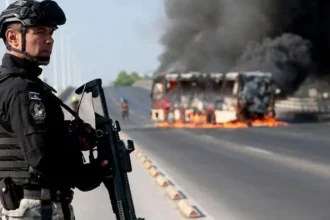 Mexico Cartel Violence Raises Concerns Ahead of 2026 World Cup Mexico’s role as co-host of this summer’s FIFA World Cup faces potential disruption after a surge in drug cartel violence, experts warn. CJNG Retaliates After Leader’s Death The Jalisco New Generation (CJNG), one of Mexico’s most feared criminal organizations, has clashed with the military, set roadblocks, and burned vehicles following the capture and killing of its leader, Nemesio Oseguera Cervantes, known as "El Mencho". The unrest began in Jalisco, where a red-alert security situation is now in place. Videos online show gunmen on patrol and smoke rising over major cities. The violence has spread to more than a dozen regions. World Cup Host Cities Affected Guadalajara, the capital of Jalisco and home to over a million residents, is set to host four matches this summer. Mexico City will host five, and Monterrey will host four. Experts caution that maintaining security in these areas will be challenging. Javier Eskauriatza, assistant professor of criminal law at the University of Nottingham, said, "Cracking down on cartels triggers pushback. Managing spiraling violence can be very difficult." Cartels’ Economic Interests Despite the violence, experts suggest cartels have a vested interest in keeping the World Cup safe. Many cartel figures invest in hotels, restaurants, and local businesses, ensuring tourists spend money without major disruptions. "Cartels benefit when international visitors enjoy themselves," Eskauriatza explains. "While they bribe officials, they also play a role in the economy, so they avoid complete chaos during major events." Security Measures and Tourist Risks The U.S. government has advised Americans in Jalisco to stay indoors, while Canada has canceled flights to Puerto Vallarta. Flight tracking apps showed planes returning to their origin points. Dr. Karina Garcia-Reyes, criminology lecturer at UWE Bristol, commented, "There is a moderate risk for tourists this summer. Authorities should manage the affected areas, and visitors should follow local guidance to stay safe." The power vacuum left by El Mencho’s death may spark further cartel conflicts as contenders compete for leadership. Analysts warn this period of instability could affect safety if not closely monitored. Preparing for the World Cup Authorities are under pressure to balance military operations with tourist safety. With proactive measures, experts believe international fans can attend the tournament safely. Still, vigilance remains crucial.