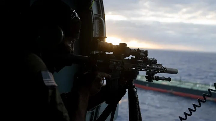 U.S. troops descending from helicopter to board Aquila II tanker