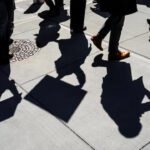 Federal employees walking outside a government building amid debate over appeal rights