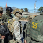 Polling place entrance with voters lined up as election officials monitor the site