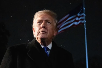 Marjorie Taylor Greene speaking at an event while Donald Trump looks on