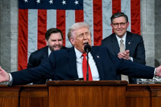 President Donald Trump speaking during his record breaking State of the Union address as Nancy Pelosi reacts