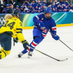 Team USA women’s hockey players celebrate a goal against Sweden at the 2026 Olympics