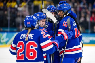 U.S. women’s hockey team celebrating after defeating Sweden to reach the Olympic gold medal game