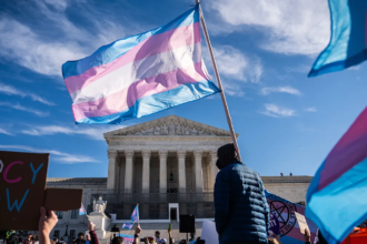 Protesters and supporters gathered outside a government building during a debate over youth gender healthcare policy