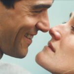 Love Story 2026 Becomes a Breakout TV Hit for Nostalgia, Fashion, and Music Why audiences are drawn to a pre digital feeling world The success of Love Story reflects a strong audience desire for life before smartphones and social media. Viewers feel tired of constant online noise and fast news cycles. The show offers a return to a slower world where daily life feels more social, physical, and spontaneous. Some viewers feel nostalgia for the 90s. Others experience something called anemoia, which is a longing for a time they never actually lived through. This gives younger audiences a sense that the past feels new, stylish, and exciting rather than familiar. New York city as a central character The show highlights New York as more than just a setting. It plays a key role in shaping the story. The characters move through fashion events, cafes, night spots, and busy offices, creating a lifestyle that feels ambitious and glamorous. Fans have also started visiting real locations featured in the series. Some restaurants have reported a rise in bookings after appearing on screen. This shows how strongly the series connects fiction with real world places and experiences. Strong cast chemistry and rising talent The lead actors have become a major reason for the show’s popularity. Their on screen connection feels natural and engaging, which helps viewers stay invested in the story. One of the lead performers had limited acting experience before this role, yet delivers a standout performance. The other lead has more experience and is now being seen as a potential award contender because of her emotional depth and screen presence. Fashion influence and 90s style revival Fashion plays a major role in the show’s appeal. The minimalist 90s style seen in the series has quickly become popular again. Viewers are recreating outfits inspired by the characters, especially clean monochrome looks and simple accessories. Search trends show a strong rise in interest in certain fashion brands featured in the show. Social media users are also copying hairstyles, clothing choices, and street style inspired by the characters. At the same time, some critics argue that copying celebrity style does not replace personal identity. Soundtrack that defines the mood The music in Love Story has received wide praise. The soundtrack blends popular 90s dance tracks with softer, emotional songs that match the tone of each scene. Many viewers say the music deepens emotional moments in the story. Certain scenes have gone viral because of how strongly the songs connect with character experiences, making the soundtrack a key part of the show’s identity. Public debate and controversy The series has also sparked debate. Early promotional images received criticism for their styling choices. Relatives connected to the real life inspiration of the story have raised concerns about how personal histories are portrayed. There has also been discussion about how some real people are represented in the show. While some viewers enjoy the dramatization, others feel certain portrayals are unfair or exaggerated. Despite this, attention and conversation around the series continues to grow.