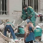 Airstrikes in Tehran trap civilians as they strike residential areas Airstrikes in Tehran have caused a wave of destruction, with families and civilians being buried beneath rubble. Although intended to target military targets, the attacks also affected residential areas. This raises serious questions about civilian safety. Waiting for a Mother Turns into Tragedy A mother in the Resalat neighborhood stood helpless next to the ruin of the apartment her daughter had occupied. She waited for days as rescuers struggled to find those who were trapped under the debris. She repeated that her daughter was alive and well under the rubble, but she was afraid of darkness. The rescue operation was slowed by a lack of manpower. Both the young daughter and mother were later found to be dead. Although the husband was still alive, the death of the daughter and her child devastated the entire family. There is widespread damage in residential zones In seconds, the strike on Resalat destroyed a number of buildings. The Basij is a paramilitary organization associated with the Islamic Revolutionary Guard Corps. Apartment blocks nearby were also destroyed. Satellite and aerial footage shows that four buildings have collapsed. The homes located as far away as 65 meters suffered severe damage. Residents reported hearing multiple explosions in seconds. This suggests that repeated attacks were made within a short period of time. A survivor remembered being thrown around the room. His home, personal items, and documents were all destroyed. After losing their homes, many families are now forced to seek shelter in hotels nearby. The Civilian Death toll is on the Rise According to local sources, this strike killed between 40-50 people. Many of the victims were civilians with no connection to military activities. The attacks were part of a conflict that has been ongoing between Iran, Israel, and the United States. The strikes are aimed at targets linked to the state, but their location in civilian areas increases the danger for non-combatants. The use of powerful bombs raises concerns Analysts believe large bombs, such as the Mark 84 and Mark 80, from the Mark 80 family were used. The weapons have a high impact and explosive power, even if they are guided by precision systems. This assessment is supported by the scale of destruction at Resalat. The entire structure was reduced to rubble and the shockwaves caused damage in surrounding buildings. Civilians caught between conflict and control Now, residents are facing a double-edged sword. One side is the constant airstrikes. They are also under tight internal control after recent crackdowns against protestors. There is a sense of helplessness among many, who have limited or no access to support and safety. The humanitarian costs are increasing as the conflict progresses, particularly in urbanized areas.