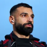 Mohamed Salah Transfer Options: Saudi Arabia or MLS Move Possible Mohamed Salah’s future is becoming a major talking point as interest grows from outside Europe. Saudi Arabia and the United States now look like the strongest options if he decides to leave Liverpool. Saudi Arabia emerges as the top option Saudi Arabia stands out as the most likely destination. Clubs in the Saudi Pro League already view Salah as a major global name and a key figure for the league’s growth. Al Ittihad previously tried to sign him with a £150 million offer in 2023, but Liverpool rejected it at the time. That move came when Jurgen Klopp was still manager, before Arne Slot later guided Liverpool to a Premier League title with Salah playing a key role. Now, Salah could leave on a free transfer, and Saudi clubs are expected to return with strong interest. The main contenders include Al Hilal, Al Nassr, Al Ittihad, and Al Ahli, all backed by Saudi Arabia’s Public Investment Fund. Al Qadsiah, linked with former Liverpool manager Brendan Rodgers and supported by Aramco, could also join the race. Football finance expert Kieran Maguire says money will not be a problem. He notes that Cristiano Ronaldo earns around £170 million a year in Saudi Arabia, while Salah earns close to £20 million at Liverpool. He also says regional tensions may still affect any final decision. MLS offers a different path The United States is another realistic option for Salah. Major League Soccer has grown fast and already attracted global stars like Lionel Messi. MLS uses a salary cap system, but clubs can sign elite players through the Designated Player rule, often called the Beckham rule. This system has helped bring players like David Beckham, Lionel Messi, and Luis Suárez to the league. Messi earns around $20 million in salary at Inter Miami, but his total income is much higher due to commercial deals and ownership benefits. MLS commissioner Don Garber has already shown interest in Salah. He has said the league would welcome him and encouraged him to speak with Messi and Thomas Müller about their experience in the United States. Clubs such as Inter Miami, LA Galaxy, and Los Angeles FC have the financial power and global reach to sign a player of Salah’s level. What comes next for Salah Saudi Arabia offers the strongest financial package and regional influence. The MLS offers global branding, lifestyle appeal, and strong commercial opportunities. Both leagues are now realistic options if Salah decides to move away from Europe