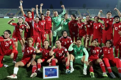 Afghanistan Women Football Team Returns to International Stage After FIFA Decision FIFA Approves Return Under Special Rules FIFA has approved a new rule that allows Afghanistan women footballers to return to international competition under special circumstances. The decision enables players to represent their country even when their national federation cannot officially support a team. This change follows years of restrictions after the Taliban took control of Afghanistan in 2021. Women were banned from sports, and many footballers left the country to seek safety abroad. Players Forced Into Exile After 2021 Afghanistan women last played an official match in 2018. After 2021, women faced strict limits on sport and public participation. Many national team players relocated to countries such as Australia, the United States, Europe, and the Middle East. More than 80 Afghan women footballers now live outside Afghanistan. Some were under contract before the political change, while others joined later as refugees. Formation of Afghan Women United FIFA supported a refugee team called Afghan Women United in 2025 as part of a pilot program. This team gave displaced players a platform to compete and stay active in international football. The team has already played friendly matches. It recorded its first win against Libya during the FIFA United Women Series in 2025. New Pathway for International Matches The updated FIFA rule allows a national or representative team to compete even when the member federation cannot officially register it. This ensures players are not blocked from football due to political or external conditions. Afghanistan will not take part in the 2027 Women's World Cup. However, the team may join qualification matches for the 2028 Olympics. Their return to international fixtures is expected in June. Leadership and Player Response Former captain Khalida Popal welcomed the decision and said the team represents strength and hope for Afghan women. She highlighted that players inside Afghanistan still face major restrictions. She said the team will continue to speak for those who cannot leave the country and will support young players in exile communities. Training and Preparation Plans FIFA has organized regional selection camps in England and Australia. A training camp in New Zealand is also planned for June. These camps will help prepare the squad for upcoming international matches.