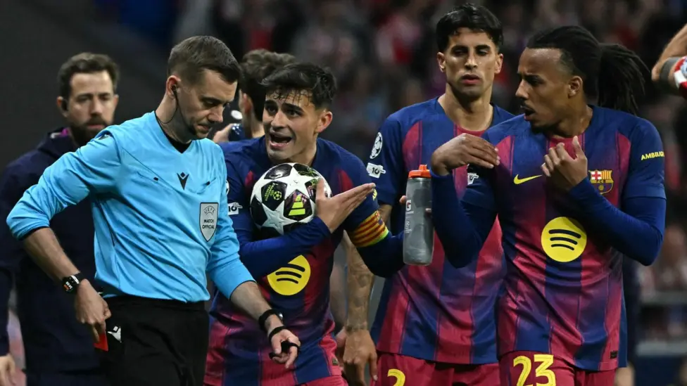 The controversy surrounding match incidents Barcelona has raised concerns following their Champions League elimination, claiming that key refereeing decision changed both legs' direction. They claim that the officials' mistakes directly affected the result of the match. The club believes that several incidents were handled incorrectly under the rules. Barcelona claims that in both games, important decisions were made against them during key moments of play. The red cards and the VAR decisions under scrutiny Pau Castrorsi was the first to be sent off after being found guilty of denying an obvious scoring opportunity. Eric Garcia was also shown a red in the second game after a pitch-side review led to the referee upgrading a yellow. Barcelona also questioned a decision involving Atletico defender Marc Pubill. He was accused of handling the ball in the penalty box, yet the game continued with no intervention by VAR or referee. These moments, according to the club, show inconsistent VAR use and decisions in both matches. Barcelona files formal complaint with UEFA Barcelona complained first after the first leg. They cited what they deemed a severe lack of VAR interventions. UEFA rejected this complaint later. The club filed a formal complaint after the second leg. The club claimed that several decisions were not in accordance with the rules of the game. Barcelona said that officials had also applied rules incorrectly to several important situations. The repeated mistakes had an impact on match results, causing both financial and sporting damage. Reaction of players and clubs Raphinha was a forward who had missed both games due to an injury. She strongly criticised refereeing in the aftermath of the second match. He called the decision-making unfair, and said that it felt like the referees had robbed both matches. Later, the club released a press release stating that they were willing to collaborate with UEFA in order to improve standards of refereeing. The club stressed that VAR should be used more fairly and transparently, and the match officials must also follow this. Club position and result Barcelona insists that refereeing errors, not pure athletic performance, determined the result. The group continues to call for a review of the officiating standard in all major tournaments.