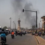 France and UK Urge Citizens to Leave Mali After Coordinated Attacks Rising insecurity across Mali after rebel and militant violence France has advised its citizens to leave Mali as soon as possible following a wave of coordinated attacks involving separatist fighters and Islamist militants. The situation in the country has been described as extremely unstable, prompting urgent travel warnings. Explosions and heavy gunfire were reported in several areas, including the capital Bamako, over the weekend. In the town of Kati, defence official Sadio Camara was killed in what authorities described as a suicide attack. In the north, separatist forces reportedly seized control of Kidal, marking a major escalation in the conflict. Government response and claims of control Mali’s military leader General Assimi Goïta addressed the public for the first time since the attacks. He stated that the army had delivered a strong response to the attackers and said security operations were still ongoing across affected regions. Despite this, rebel groups have continued to issue strong statements. A spokesperson for the Azawad Liberation Front (FLA), Mohamed Elmaouloud Ramadane, said the movement aims to expand control into other northern cities, including Gao, Timbuktu, and Menaka. He also called for Russian forces supporting Mali’s military government to withdraw from the country. International travel warnings France’s foreign ministry urged its nationals to leave Mali using available commercial flights. Citizens still in the country were told to remain indoors, avoid unnecessary movement, and stay in contact with family members. The ministry also clearly warned against all travel to Mali, regardless of purpose, due to worsening security risks. The United Kingdom issued similar guidance. It advised its citizens to leave immediately if they can do so safely. It also warned against traveling by road to neighboring countries, citing the risk of terrorist attacks along major routes.