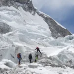 A massive glacier block is delaying Everest climbs as teams wait for a safe route to open during peak season.