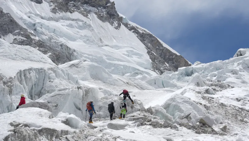 A massive glacier block is delaying Everest climbs as teams wait for a safe route to open during peak season.