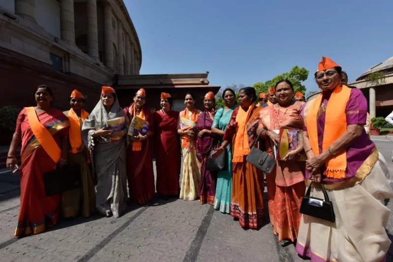India's Women Quota Bill Triggers a Political Debate over Seat Redistribution The government pushes for historic reforms of women's reservations India has made a constitutional change that will reserve 33% of the seats in state and national legislatures for women. This is a much-anticipated step towards greater female representation in the political arena. Narendra Modi, Prime Minister of India, described this proposal as an important shift in the country. He said it would improve decision-making quality and bring more balance to the parliament. The Prime Minister also stated that there are plenty of women who can take on leadership positions. Currently, around 14% women are represented in the lower chamber. The reform, if approved by the Indian parliament, would increase this share significantly and move India towards global averages in terms of female representation. Concerns raised by the link between the women's quotas and redrawing of constituencies This bill is part of a larger plan that aims to redistribute parliamentary districts based on data about population. Delimitation is a process that adjusts seat distribution between states. It could also increase the number of seats in lower house, from 543 up to 850. The opposition parties are concerned about the structure and timing of the plan. The opposition parties argue that linking the women's reservations with changes in constituency creates an unnecessary level of complexity to what is supposed to be a simple gender reform. Some legislators also claim that the government moves too fast during an electoral period, and shouldn't make major structural changes now. Debattion on fairness, federal balance India's Constitution requires that parliamentary seats be assigned based on the population. This is updated periodically after every census. The country hasn't carried out a full delimitation of constituencies since 1971. The previous governments held back the process because they were concerned that differences in population between states might create an uneven influence on politics. This proposal is based on the census of 2011, which marks a departure from previous caution. Some supporters argue this is needed to modernize the representation. Critics say it will reshape the political power of regions. Support for political parties still unclear The coalition that currently controls the government does not have the required two-thirds majority to approve the amendment. The opposition and smaller parties will be needed to support the move. The opposition is divided on how to implement the change.