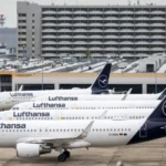 Lufthansa Cuts 20,000 Flights as Fuel Prices Surge Rising Fuel Costs Force Major Flight Reductions Lufthansa has announced it will cancel around 20,000 short-haul flights this summer. The airline says rising fuel prices have made many routes too expensive to operate. Jet fuel prices have sharply increased since the start of the conflict involving the US, Israel, and Iran. The situation has slowed production and disrupted supply routes across the Middle East. Airlines Pass Costs to Travelers Other major airlines, including Air France–KLM and Delta Air Lines, have also reduced some flights. At the same time, many carriers have raised ticket prices to cover higher costs. Industry experts warn that ticket prices may continue to rise. Travelers could also face more cancellations if the situation does not improve. Middle East Supply Disruptions Impact Europe The Middle East plays a key role in global jet fuel supply. It provides about half of Europe’s aviation fuel imports. Much of this supply passes through the Strait of Hormuz. Iran has restricted access to this route in response to recent military actions. This has caused delays and reduced fuel availability. The International Energy Agency recently warned that Europe could face jet fuel shortages within weeks. However, UK officials and airlines say they have not yet seen major supply disruptions. Lufthansa Adjusts Network Strategy Lufthansa confirmed it will scale down its European routes. However, it will continue to operate long-haul international flights. The airline said this move will improve efficiency and reduce fuel use. It expects to save around 40,000 metric tons of jet fuel. Fleet Changes and Route Cuts The airline has also decided to speed up the closure of its CityLine operations. It plans to retire 27 aircraft as part of this move. Lufthansa said higher fuel costs and ongoing labor issues influenced this decision. Some of the first route cuts have already started. These include flights from Frankfurt to cities in Poland and Norway.