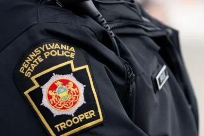 Tragic House Explosion in Clinton County A devastating explosion destroyed a home in Lamar Township, Clinton County, Pennsylvania, on Sunday morning. Authorities confirmed that a 34 year old mother and her six children died in the incident. The children included four boys and two girls, aged between three and eleven. Emergency services arrived at about 08:30 local time after reports of an explosion. They found the house fully on fire and heavily damaged. Fire Spread Before Rescue Could Begin Firefighters reached the scene quickly but faced extreme conditions. The flames spread through the structure at high speed. Officials reported that responders could not safely enter the home to search for survivors. The intensity of the fire caused part of the house to collapse before rescue operations could begin inside the structure. Suspected Cause Under Investigation Investigators believe a propane leak inside the home may have triggered the explosion. However, they have not confirmed the final cause yet. Authorities continue to examine the site and gather evidence. Police stated that the investigation remains active and further findings will be shared once available. Witness Account of the Explosion A nearby resident described hearing a loud blast during breakfast. She said the impact was strong enough to be felt inside her home. She looked outside and saw flames coming from the house. Within a very short time, the entire structure was engulfed in fire. Other neighbors rushed out to call emergency services. Fire crews arrived soon after but reported that the fire had already consumed most of the building. Community Reaction and Ongoing Inquiry The local community expressed shock and grief over the loss of a young family. Neighbors described the fire as fast and overwhelming, leaving almost no time for intervention. Authorities continue to investigate the explosion to determine exactly what caused the propane leak and how the fire spread so quickly.