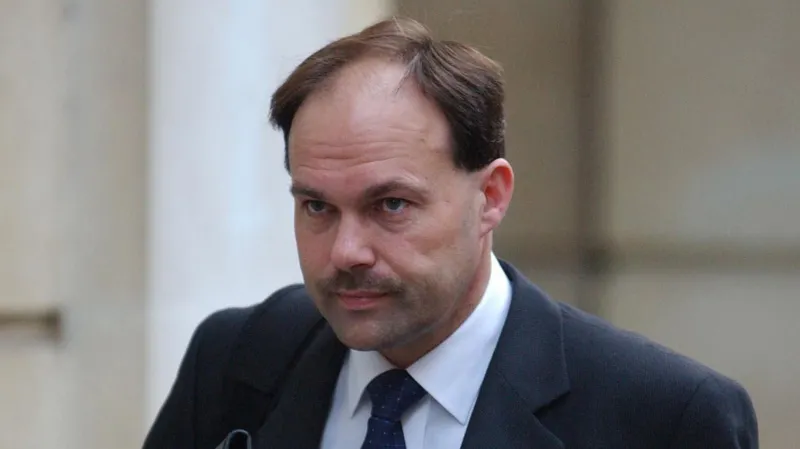 The family of the murderer who hid his wife's body was outraged, but he received a pardon. The Case Background Glyn Razzell was convicted of murdering his wife Linda Razzell in 2003. He has been granted parole. This decision has been met with strong reaction, particularly from the family of victim. Linda vanished in 2002, while on her way to Swindon. She was divorcing Razzell at the time. She had frozen his accounts a few days before her disappearance. Investigators were able to build a solid case even though her body wasn't found. The forensic evidence, which included traces of blood from her in the car that was linked to Razzell's, contributed to his conviction. He was sentenced to life imprisonment with a minimum of 16 years. The Parole Case and its Legal Context Razzell was reviewed by the Parole board multiple times. Previous applications for release, such as one made under Helen's Law 2021, were denied. Helen's Law obliges officials to take into account the psychological harm that is caused by offenders who refuse to disclose the location of the remains of victims. It does not, however, prevent release. The board's latest assessment in January 2026 concluded that Razzell does not pose a threat to public safety. The members noted Razzell's behavior while in jail and his ability, when not under custody, to adhere to rules. The court also recognized the hurt caused by his refusal of revealing where Linda's remains are. They still emphasized the fact that the risk of harm to the public is the main factor when deciding whether or not to grant parole. Families React and Continued Pain Linda's family members have been deeply affected by the ruling. Greg Worrall said that the ruling has added further emotional stress to the lives of those who loved Linda. They believe that the decision weakens Helen's law. The family argues that justice is incomplete until answers are given about Linda's last resting place. Government Response Now, the Ministry of Justice will review this decision. The officials are examining whether or not they can contest it by way of a judicial reconsideration. If valid grounds can be found, this step may delay the release or even reverse it. Justice vs Public Safety: The key issue The case illustrates a delicate balance. The authorities must balance public safety with the suffering experienced by victims' families. The system is primarily focused on managing risk, but families are often looking for closure and accountability. The absence of answers is causing frustration and anger in this case.