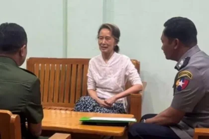 Myanmar’s military says Aung San Suu Kyi has been moved from prison to house arrest after a sentence adjustment.