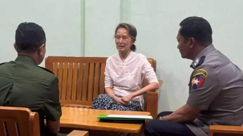 Myanmar’s military says Aung San Suu Kyi has been moved from prison to house arrest after a sentence adjustment.