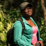 Nigerian Scientist Wins Global Recognition for Bat Conservation Efforts Wildfires Spark a Conservation Mission Nigerian ecologist Iroro Tanshi began her conservation work after witnessing the impact of wildfires in Afi Mountain Wildlife Sanctuary in south eastern Nigeria. During her field research, she discovered the short tailed roundleaf bat, a species not widely seen for nearly 50 years. Shortly after this discovery, she observed that uncontrolled fires were putting the species at serious risk. Instead of focusing only on research, she shifted her attention to protecting both the bats and their habitat. She identified human caused wildfires as one of the main threats to survival in the region. Community Led Fire Prevention Strategy To address the issue, Tanshi worked closely with local communities living around the sanctuary. She helped establish community fire brigades that actively monitor and prevent wildfires. Between 2022 and May 2025, these efforts stopped major fire outbreaks across a large protected area of 24700 acres. Her approach linked conservation with everyday community challenges. By addressing fire risks that directly affected local livelihoods, she built trust and participation among residents. Changing Beliefs About Bats In many parts of Nigeria, bats are often linked to superstition and witchcraft, which leads to fear and misunderstanding. Tanshi and her team worked to change these beliefs through education campaigns. They used different forms of communication, especially outreach programs for children, to explain the ecological importance of bats. She emphasized that bats play a key role in ecosystems by dispersing seeds and supporting plant growth. She also highlighted how everyday products rely on bats. For example, she explained that shea butter production benefits from bat driven seed dispersal. Global Recognition for Environmental Impact Her work earned her the Goldman Environmental Prize, a major international award recognizing grassroots environmental leadership. The award highlights her success in combining science, education, and community engagement to protect endangered wildlife. Tanshi currently works as a postdoctoral researcher at the University of Washington, where she continues her focus on bat conservation.