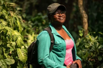 Nigerian Scientist Wins Global Recognition for Bat Conservation Efforts Wildfires Spark a Conservation Mission Nigerian ecologist Iroro Tanshi began her conservation work after witnessing the impact of wildfires in Afi Mountain Wildlife Sanctuary in south eastern Nigeria. During her field research, she discovered the short tailed roundleaf bat, a species not widely seen for nearly 50 years. Shortly after this discovery, she observed that uncontrolled fires were putting the species at serious risk. Instead of focusing only on research, she shifted her attention to protecting both the bats and their habitat. She identified human caused wildfires as one of the main threats to survival in the region. Community Led Fire Prevention Strategy To address the issue, Tanshi worked closely with local communities living around the sanctuary. She helped establish community fire brigades that actively monitor and prevent wildfires. Between 2022 and May 2025, these efforts stopped major fire outbreaks across a large protected area of 24700 acres. Her approach linked conservation with everyday community challenges. By addressing fire risks that directly affected local livelihoods, she built trust and participation among residents. Changing Beliefs About Bats In many parts of Nigeria, bats are often linked to superstition and witchcraft, which leads to fear and misunderstanding. Tanshi and her team worked to change these beliefs through education campaigns. They used different forms of communication, especially outreach programs for children, to explain the ecological importance of bats. She emphasized that bats play a key role in ecosystems by dispersing seeds and supporting plant growth. She also highlighted how everyday products rely on bats. For example, she explained that shea butter production benefits from bat driven seed dispersal. Global Recognition for Environmental Impact Her work earned her the Goldman Environmental Prize, a major international award recognizing grassroots environmental leadership. The award highlights her success in combining science, education, and community engagement to protect endangered wildlife. Tanshi currently works as a postdoctoral researcher at the University of Washington, where she continues her focus on bat conservation.