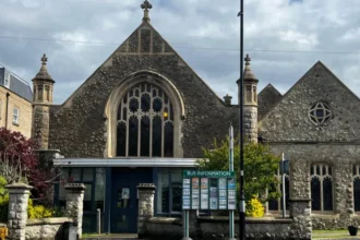 Police Confirm No Rape Outside Epsom Church After Investigation Surrey Police have closed their investigation into an alleged rape outside a church in Epsom. Officers confirmed that no sexual offence took place. The case began when a woman in her 20s reported that she had been raped outside Epsom Methodist Church on 11 April. She had just left Labyrinth nightclub earlier that night. Her report quickly spread, causing concern across the town. Investigation Findings Police carried out a detailed investigation. They reviewed CCTV footage, spoke to witnesses, conducted house visits, and completed forensic tests. After examining all evidence, officers found no sign of a sexual assault. Instead, they believe the woman suffered an accidental head injury during her night out. This injury likely caused confusion, which led to the initial report. Authorities confirmed that the woman agreed to share this update. She is still receiving support from relevant services. A police spokesperson said they treat every report of sexual offences seriously and handle each case with care and sensitivity. Public Reaction and Disorder The initial report triggered strong public reactions. Large groups gathered in Epsom, demanding information about suspects. However, police did not release any descriptions due to a lack of confirmed details. As tensions rose, protests turned disruptive. Some individuals threw objects at police officers. Authorities responded by deploying riot police to control the situation. Five people, aged between 15 and 23, were later arrested. They face charges related to public order offences and criminal damage. All have been released on bail. Misinformation and Community Impact Police also addressed false claims circulating during the unrest. Some people targeted hotels and homes based on rumors that asylum seekers were involved. Authorities stated that these claims were completely untrue. Officials criticized the violence and misinformation. Surrey Police and Crime Commissioner Lisa Townsend described the incidents as “shameful” and “mindless.” She also noted that some individuals involved were not from the local area. Police Statement Surrey Police emphasized their commitment to thorough investigations. They confirmed that this case involved careful evidence review before reaching a conclusion. The force also urged the public to avoid spreading unverified information, as it can lead to unnecessary fear and disorder.