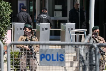 Istanbul Israeli Consulate Shooting: One Gunman Killed, Two Injured After a gun battle with the police, one of two attackers was killed and another injured in a shooting near the Israeli Consulate in Istanbul. The incident has been described by authorities as an act of serious terrorism that raises concerns over security. Attack Near Consulate Sparks Panic In Istanbul, the incident occurred in Besiktas's bustling district where Israel consulates are located. Officials claim that the attackers drove from Izmit to Istanbul in a rental car, and then attacked in broad daylight. The gunfire between suspects and officers lasted several minutes. The witnesses reported that the shooting was loud and continued, causing panic in nearby people. Police Respond, One Attacker Killed The security forces responded quickly to the attack and engaged with the attackers. During the gunfight, one of the attackers was killed and two other suspects were injured. Later, authorities confirmed that two of the suspects were brothers. In the shooting, two police officers also sustained injuries. Two police officers were also injured in the shootout. One was hurt on the leg, and the other got hit by a bullet to the ear. Both officers are in stable conditions and receiving medical attention. Extremist Groups and Suspects The dead attacker was identified by officials as Yunus E.S. The authorities stated that the attacker had links with a religious extremist group, which is widely thought to be Islamic State. No organization has yet claimed official responsibility for this attack. The investigation is also looking into the digital communications between suspects. No Diplomatic Staff Harmed The consulate was empty at the time the attack occurred. It prevented further violence and possible casualties. The police sealed the area off for several hours following the incident. Online videos show an intense police presence at the incident, as well as emergency response teams. The Government condemns the Attack The Turkish president Recep Tayyip Erdoan condemned the attack, calling it an "heinous terror act." Erdogan stressed that such incidents will not disrupt public safety or trust. The authorities have confirmed that the investigation is ongoing and are taking strict measures to avoid similar incidents occurring in future.