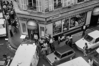 Palestinian Suspect Handed Over to France in 1982 Paris Restaurant Attack Case A Palestinian suspect has been handed over to French authorities in connection with the deadly 1982 attack on a Jewish restaurant in Paris. The move comes decades after the incident shocked the country and left victims’ families waiting for justice. The suspect, Hicham Harb, arrived at Villacoublay air base near Paris, where officials immediately placed him in detention, according to France’s anti-terror prosecutors. Details of the 1982 Rue des Rosiers Attack The attack took place at the Jo Goldenberg restaurant in Paris’s historic Marais district. Armed attackers threw a grenade into the crowded restaurant before opening fire with machine guns. Six people lost their lives, and more than 20 others suffered injuries. Panic spread as customers tried to escape the violence. Despite the severity of the attack, no one has been convicted for the killings so far. Suspects and Legal Developments In 2024, France’s highest court ordered a trial for six suspects linked to the attack. Three of them are still abroad, reportedly living in the West Bank, Jordan, and Kuwait. Two suspects are already in France. Norwegian citizen Abou Zayed is accused of being one of the gunmen, though his lawyers deny any involvement. Another suspect, Hazza Taha, is believed to have helped store the weapons used in the attack. Harb’s family has raised concerns about his extradition. His son claims the process was unlawful and fears that he may not receive a fair trial. However, French courts rejected requests to move the case to a jury trial. Instead, judges in a special court will handle it. Links to Abu Nidal’s Militant Group Investigators believe the attack was carried out by a faction linked to Abu Nidal, a well-known militant leader. His group had broken away from the Palestine Liberation Organization and was responsible for several violent incidents in the 1980s. The organization carried out attacks worldwide, including plane hijackings, assassinations, and shootings. These actions led to hundreds of deaths during that period. France Pushes for Justice After Four Decades French Foreign Minister Jean-Noël Barrot recently met families of the victims. He assured them that authorities remain committed to holding those responsible accountable. He emphasized that France continues to fight against terrorism and anti-Semitism. After more than 40 years, officials say this case could finally bring long-awaited justice.