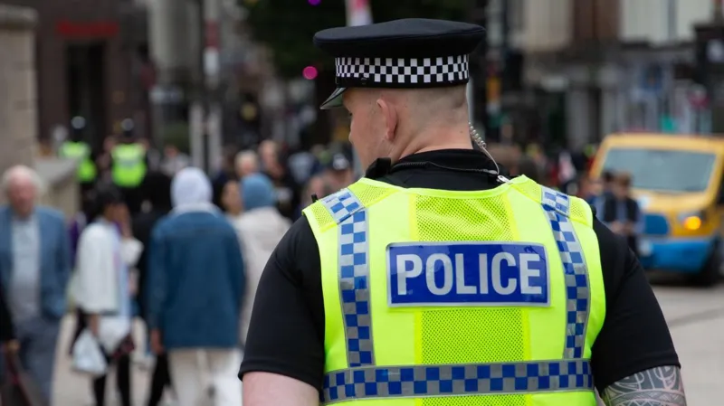 Police Arrest Two in West Midlands Drug Sales Case Police in the West Midlands have arrested a man and a woman for allegedly supplying illegal drugs through local shops. Officers carried out the arrests on Thursday in Dudley as part of an ongoing crackdown on street-level drug activity. Authorities confirmed that both suspects remain in custody for questioning. Investigators also stated that more arrests are likely as the operation continues. Shops Used as Drug Distribution Points Recent findings exposed a worrying trend. Small retail shops across several towns have been used to sell illegal substances. These include cocaine, cannabis, laughing gas, and even prescription pills. Undercover checks revealed that some shopkeepers or associates openly offered drugs to customers. This has raised serious concerns about how easily such substances can reach the public. Nationwide Pattern Raises Alarm The issue is not limited to one area. Reports from multiple regions across the UK show similar patterns. Investigators have linked over 70 shops and related locations to drug activity. Authorities discovered dangerous substances such as crystal meth and heroin in these places. Law enforcement agencies believe organized criminal networks are behind this trend. These groups use small businesses as a cover to expand their operations. Police Response and Ongoing Investigations West Midlands Police have made it clear that they will not tolerate this activity. Officers are actively investigating multiple leads and working to identify others involved. A police spokesperson said they are aware of growing public concern. They reassured residents that strong action is already underway to stop illegal drug sales and protect communities. Government Plans Stronger Action The UK government has also responded to the situation. Officials have promised stricter measures to tackle crime on high streets. Plans include increasing the number of visible neighbourhood police officers. Authorities also want to give officers more power to deal with anti-social behaviour and illegal trade in shops. Political Reactions to Rising Crime Political leaders have reacted strongly to the revelations. Some have described the situation as a sign of increasing lawlessness in towns and cities. Proposals include hiring thousands of additional police officers and using advanced surveillance tools in crime-prone areas. Leaders say these steps aim to restore safety and public confidence.