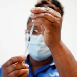 The UK Covid vaccine rollout is praised as an extraordinary achievement in a new inquiry report, saving over 475,000 lives while highlighting gaps in trust and compensation.