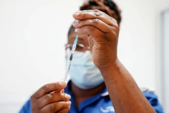 The UK Covid vaccine rollout is praised as an extraordinary achievement in a new inquiry report, saving over 475,000 lives while highlighting gaps in trust and compensation.