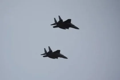 South Korean Fighter Jets Collide Mid-Air After Pilots Attempt Aerial Photos A recent investigation in South Korea has revealed that a mid-air collision between two fighter jets in 2021 was caused by pilots trying to capture photos and videos during a mission. The incident took place near the central city of Daegu and involved two F-15K aircraft from the country’s air force. What Happened During the Flight According to findings released by the Board of Audit and Inspection, the jets were returning to base after completing their mission. During the flight, one pilot, flying as the wingman, decided to take photos using his personal phone. He wanted to mark his final mission with his unit. Taking such photos was reportedly common among pilots at the time. The pilot had even mentioned his plan during the pre-flight briefing, which suggests the practice was informally accepted. The Maneuver That Led to the Collision While taking photos, the wingman pilot suddenly changed position. He climbed higher and flipped the aircraft to get a better angle for the camera. This move brought the jet dangerously close to the lead aircraft. At the same time, the lead pilot asked a colleague to record video footage of the wingman jet. As the aircraft moved closer, the lead jet attempted a quick descent to avoid contact. Despite this effort, the two jets collided mid-air. The crash caused damage to both planes. The lead aircraft’s left wing was affected, while the wingman jet suffered damage to its tail stabiliser. Fortunately, all pilots survived without injuries. Financial Damage and Investigation Outcome The collision resulted in repair costs of around 880 million South Korean won, which equals roughly $596,000. Initially, the air force held the wingman pilot fully responsible and demanded he cover the entire cost. However, the pilot appealed this decision. He argued that the lead pilot was aware of the filming and did not stop it. After reviewing the case, the audit authority reduced the fine to 88 million won, placing partial responsibility on the air force as well. The report stated that the military failed to set clear rules about personal camera use during flights. This lack of regulation contributed to the risky behavior. Disciplinary Action and Aftermath Following the incident, the wingman pilot was suspended from duty. He later left the military and moved into a career in commercial aviation. The case has raised concerns about safety standards and discipline within the air force. It also highlights the risks of distractions during critical operations.
