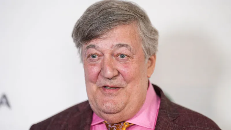 Stephen Fry files injury claim after stage fall at CogX Festival Serious fall after keynote speech British actor and writer Stephen Fry has filed a legal claim after a serious accident at a tech event in London. The incident took place at the CogX Festival, held at the The O2 Arena in September 2023. Fry had just finished his keynote speech on artificial intelligence. He turned to leave the stage but stepped into an unprotected edge. He fell nearly six feet onto a concrete floor behind the stage. Multiple injuries reported The fall caused severe injuries. Fry broke his leg in more than one place. He also suffered fractures in his hip, pelvis, and ribs. Despite the impact, he avoided damage to his spine and head. He later shared that he felt lucky to escape even worse harm. The recovery process took time and careful medical support. Legal action and claims Fry has now filed a personal injury claim in the High Court. He is seeking up to £100,000 in damages. The case targets CogX Festival Ltd and Blonstein Events Ltd. His legal team argues that the stage area was unsafe. They claim the space lacked proper lighting and clear safety barriers. According to the filing, these failures led directly to the fall. Response from organisers CogX representatives have not shared details due to the ongoing case. They confirmed concern for Fry’s condition and wished him a full recovery. Blonstein Events Ltd said it has not received official legal documents yet. The company also stated it does not accept responsibility and is ready to defend its position. What happens next The claim must be formally delivered to the defendants. After that, the court will review both sides. The final decision will determine who is responsible for the incident.