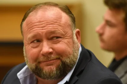 Legal Dispute Background A new twist emerges as The Onion shifts toward transforming Infowars into a platform built on satire. Amid legal battles, Alex Jones confronts steep financial consequences due to misinformation surrounding the Sandy Hook tragedy. Years passed before Jones acknowledged the incident actually happened. Though he claimed his earlier statements fell within legal rights to speak freely, judges did not accept this reasoning. Compensation was awarded to grieving relatives after rulings found harm in false claims. Legal decisions ultimately sided firmly with those who lost loved ones. Bankruptcy and Asset Liquidation By 2022, mounting legal challenges pushed Jones into bankruptcy. Well before summer of 2024, a ruling required selling off his private belongings to pay victim relatives. That decision came after a prior bid from The Onion to take over Infowars failed. Judges questioned how the sale was handled, noting it likely undervalued what could have been gained. Now contesting a decision that might lead to selling his business, Jones remains firm. Still, he insists the broadcast will carry on just as before. The Onion's Satirical Take Now shaping its next move, The Onion aims to acquire publishing access to Infowars outlets. By doing so, it could introduce parody pieces designed to confront conspiracy narratives and false digital claims. For half a year, the deal stands active - potentially longer if renewed. Fictional figures appear under Ben Collins’ leadership, shaped by outlandish plots. Mockery drives the approach: mimicking internet influencers pushing false claims or risky wellness tips. If the court gives approval, proceeds from the project might support families of Sandy Hook victims, Collins pointed out. What Happens Next Though the plan awaits official sign-off, Jones insists on pushing back. What happens next could redefine Infowars’ path - alongside court approaches to media outlets spreading false claims.