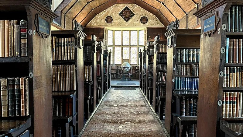A 750-Year-Old Library That Still Tells Its Story The Merton College Library is more than a place for books. It is a piece of living history that dates back over seven centuries. Founded in 1276 this remarkable library existed long before the Aztec Empire even began. I find it amazing that it has been around for long. In its days books were stored in a locked chest instead of on shelves. A few people had access to it. Three key-holders had to come to unlock it. Books were not easy to replace then. Each one was written by hand, which took months to do. That made them very valuable. How the Library Began The librarys roots go back to a rule set by the Archbishop of Canterbury in the century. The college fellows had to donate books. This simple rule helped build one of the academic collections in England. I think it's cool how a simple rule led to something big. At that time libraries looked very different. There were no rows of shelves or casual browsing. Instead books were carefully. Loaned out through a formal process. The community would gather when access was needed which made reading a shared activity. People would come together to read and discuss books. A Legacy That Spans Generations Over the centuries the Merton College Library has served notable figures. Scholars from the century studied there. Later famous writer J.R.R. Tolkien also used its resources. The librarys long history even stretches across global events like the Black Death and the COVID-19 pandemic. I am amazed by its continuity. This uninterrupted use makes the Merton College Library unique. Few institutions can claim such a history. Why Its History Matters Today During the period many believed it was the oldest library in England. Some even claimed it was the oldest in the world. Today historians take a careful view. They say defining a "library" is not simple. Early collections developed in stages and not all looked like libraries. Still Mertons collection remains special. Its long survival, traditional systems and cultural impact make it stand out. Today it offers a glimpse, into how knowledge was preserved and shared in the medieval world. The Merton College Library is a treasure that continues to tell its story.