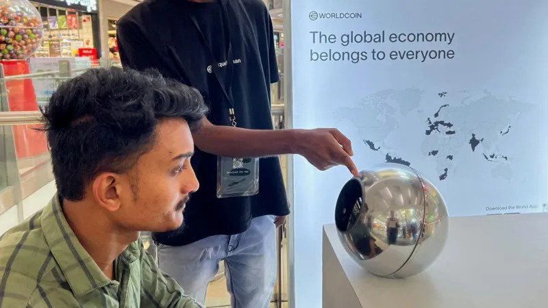 Tinder, Zoom and Tinder users can now be verified by using eye scans Tinder and Zoom have launched a new system of identity that relies on iris scans to verify whether or not a person is human. This feature is intended to help reduce the number of fake accounts, bots and AI-generated identities, which are increasingly difficult to detect on the internet. After the eye scan, users receive a badge that says "Proof of Humanity". The badge is displayed on the user's profile to prove that they are a genuine person. The Iris Scan system works The user can verify their identity using a mobile application or an orb-shaped scanner. This scans captures the colored portion of the eye, the iris. After the scanner is approved, a digital ID called World ID will be created. The ID can be stored in the phone of the user and used on all supported platforms. World Network Behind the Technology Worldcoin, formerly known as Worldcoin, is the source of this technology. The technology is being developed by Tools for Humanity. Sam Altman co-founded and chairs the startup, which also runs OpenAI. As online content grows increasingly automated, the company claims that this system will separate human accounts from AI-driven ones. Why platforms are adopting it Tinder is facing a problem of fake profiles and fraudulent accounts. These accounts often use AI to create convincing images and conversation to fool users. Match Group which is Tinder's owner, added video self-portrait checks. This new option to scan your iris is intended to provide a more robust level of security. Zoom also faces a new risk. The DeepFake Technology has enabled people to pretend to be real during video chats, such as executives or coworkers. Growing Concerns About AI Scams The use of deepfake fraud is on the rise. One reported case from Hong Kong involved a worker being tricked by AI-generated fakes into sending $25 million. In the next few years, AI-driven fraud may cause losses of tens or even hundreds of millions of dollars. The Next Step World ID will allow Tinder and Zoom to scan their iris and verify identity if desired. These companies claim that this will help to restore trust when it comes to online interactions, where AI impersonation has become more prevalent.