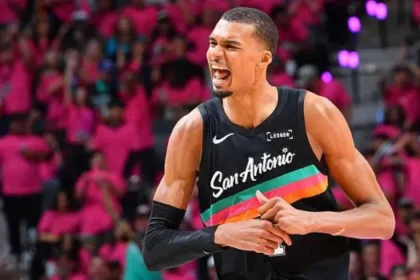 Wembanyama Makes NBA History With Unanimous Defensive Player of the Year Win Historic NBA Defensive Award for Wembanyama Victor Wembanyama of the San Antonio Spurs has won the NBA Defensive Player of the Year award in a historic sweep. Every voter selected him for first place, making him the first player ever to win the award unanimously in its 43 year history. At age 22, he also becomes the youngest player to earn this honor. He is only the second player to win it within his first three NBA seasons, following Spurs legend David Robinson. Wembanyama said he felt proud and very happy, especially about the unanimous support from voters. Dominant Season on Both Ends of the Court Wembanyama led the league in blocks for a third straight season with an average of 3.1 per game. He also posted career highs in scoring at 25 points per game and 11.5 rebounds per game. He added one steal per game, showing strong all around defensive impact. His presence changed how teams attacked the basket. Many opponents avoided the paint when he was on the court because of his shot blocking ability. German basketball legend Dirk Nowitzki praised his impact, saying he has never seen a defender who alters games so strongly just by being on the floor. Spurs Defensive Strength and Team Success The San Antonio Spurs finished the regular season with a 62 wins and 20 losses record. Their defense ranked third in the league, a major factor in their success. Wembanyama also helped push the Spurs into one of the top playoff positions. His performances have made him a strong contender for the Most Valuable Player award as well. Strong Competition in Award Voting Oklahoma City Thunder center Chet Holmgren finished second in voting with 239 points. Ausar Thompson of the Detroit Pistons came third with 60 points. Despite strong competition, Wembanyama secured all first place votes, separating himself clearly from the rest of the field. Playoff Action Around the League The Cleveland Cavaliers took control of their series against the Toronto Raptors with a 115 to 105 win. Donovan Mitchell scored 30 points while James Harden added 28. The Minnesota Timberwolves made a strong comeback against the Denver Nuggets, winning 119 to 114 after trailing by 19 points. Anthony Edwards led with 30 points and 10 rebounds. The Atlanta Hawks also secured an away win over the New York Knicks, taking the game 107 to 106 in a close finish.