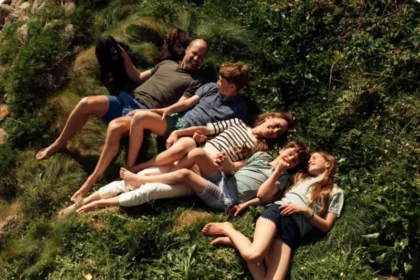 Royal Couple Celebrate 15 Years of Marriage Prince William and Catherine, Princess of Wales, marked their 15 years of marriage by sharing a new family portrait on social media. The couple posted a heartfelt image with a simple heart emoji and a caption celebrating their anniversary. The photo shows the royal family relaxed on grass during an Easter break in Cornwall. Photographer Matt Porteous captured the moment. Family Moment in Cornwall In the image, William and Catherine smile alongside their children, Prince George, Princess Charlotte, and Prince Louis. Their family dog also appears in the portrait. The setting reflects a calm and personal family moment away from official duties. Wedding and Early Life Together The couple married at Westminster Abbey in London in 2011 in a global televised ceremony. They first met while studying at the University of St Andrews. After their wedding, they spent their early married years in Anglesey. Prince William trained there as an RAF search and rescue pilot. He later reflected positively on that period, saying he valued the experience, the work, and the strong sense of teamwork. Growing Family Over the Years Prince George was born in 2013, marking the couple’s first child. Princess Charlotte followed two years later, and Prince Louis was born in 2018. The family has since become one of the most followed royal households in the world.