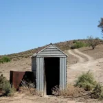 A woman was rescued after falling into a collapsed pit toilet in the Australian outback and being trapped for three hours before a passerby helped save her.