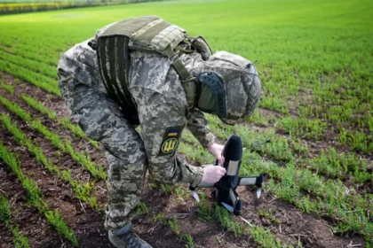 Ukraine expands drone defense using AI and private sector support Ukraine is strengthening its air defense system to counter growing drone attacks. The country is combining artificial intelligence, private companies, and ground based weapons to protect its airspace and critical infrastructure. Building a nationwide detection network Officials are working on a system that can monitor the entire country and identify incoming threats in real time. A senior coordinator involved in the project said the goal is to use every available resource to track targets across all regions. This approach focuses on full coverage of Ukrainian airspace. The system is designed to improve response speed and reduce gaps in detection. Private companies join air defense efforts Around twenty five private companies have joined the initiative. Many of them see this as both a national duty and a way to protect their own facilities. These companies are now contributing technology, infrastructure, and operational support to strengthen Ukraine’s defense capacity. Protecting energy and industrial infrastructure Russia has repeatedly targeted Ukraine’s energy grid, especially during winter months. These strikes have caused widespread power outages and disruption for millions of people. To reduce damage from future attacks, private sector partners are helping secure factories, power facilities, and other critical sites. Armed drone defense systems in frontline regions One private company, Carmine Sky, is already working in the Kharkiv region near the border area. The company has developed a network of towers equipped with remotely operated machine guns. These systems are designed to detect and destroy incoming drones before they reach sensitive targets. The setup allows faster response and reduces risk to human operators. AI driven air defense strategy Artificial intelligence plays a key role in coordinating detection and response. It helps process surveillance data and supports faster decision making in high pressure situations. Ukraine aims to connect these systems into one unified defense network that can respond quickly to multiple threats at the same time.